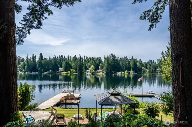 View of Pine Lake from the main house.  Plenty of room to play, deep water dock for swimming and fishing, and the floating barge at the end of the dock, with motor, is included.      The barge is perfect for sunset cruises around the lake with friends.
