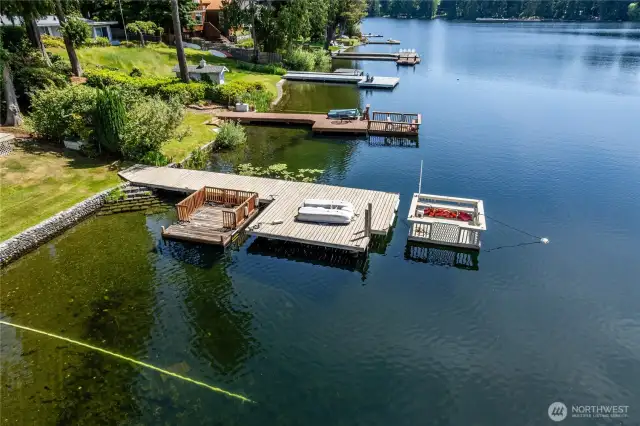 Great view of the deep-water dock with a swim ladder....look how clear the water is....The party barge is the floating dock looking thing at the right end of the dock.  It comes with an electric motor.