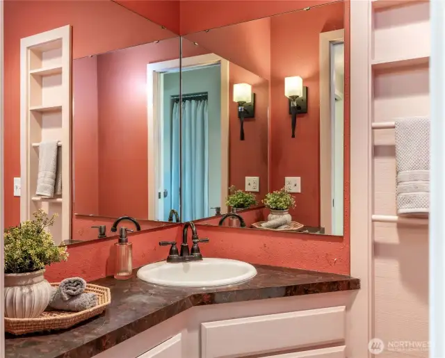Half bath on main level off hallway near kitchen.