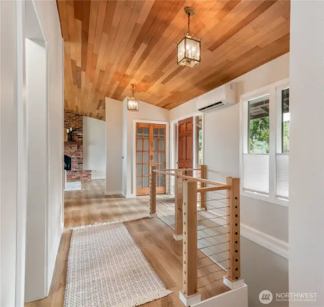 View to front door and stairs to the lower level.