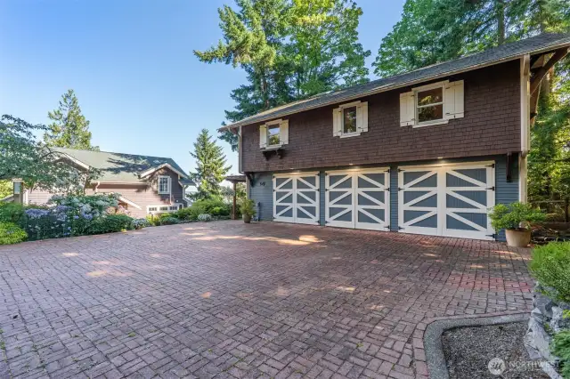 Three-car garage with carriage doors.