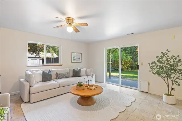Lower-level family room with sliding glass doors leading to the backyard and hot tub—perfect for indoor-outdoor living.
