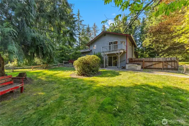 Fully fenced backyard with lawn, mature trees, and plenty of room to play or garden peaceful outdoor living right at home.
