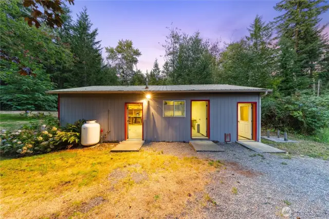 Outbuilding with three separate entrances, each leading to flexible spaces—workshop, storage, and office—all powered and ready for your projects or hobbies.