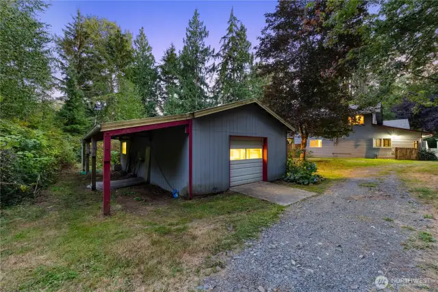 Versatile 720± sq. ft. outbuilding with garage door and covered side storage