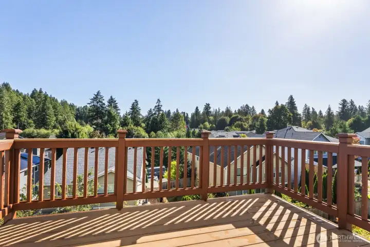 Refreshed deck with new boards and rails for added durability, offering a relaxing space to enjoy views of lush greenery above the roofline.
