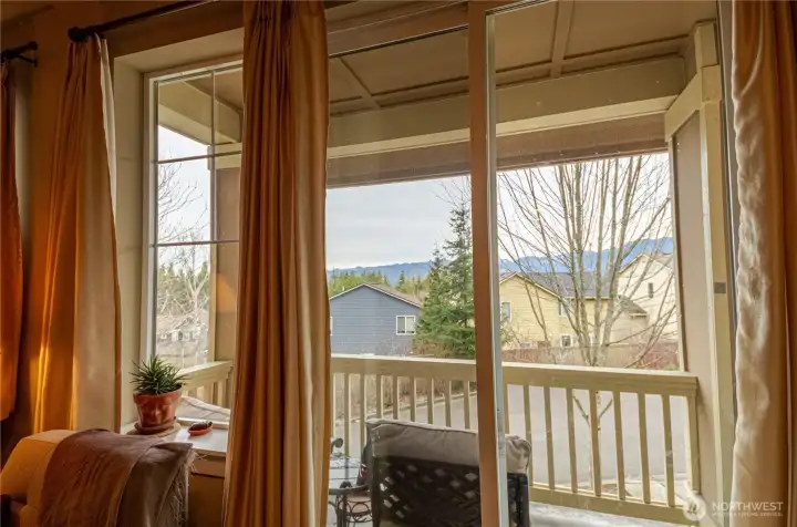 A Mountain View balcony just off the living area....covered to protect you from elements and perfectly situated for viewing the majestic Cascade mountain range. It's  a place where you can sit with a morning cup of coffee and be rewarded with a beautiful sunrise or enjoy a lazy summer afternoon relaxing with a refreshing beverage. There is room for ample seating, a little table, an outdoor rug and plenty of potted plants to make the space comfortable and welcoming.