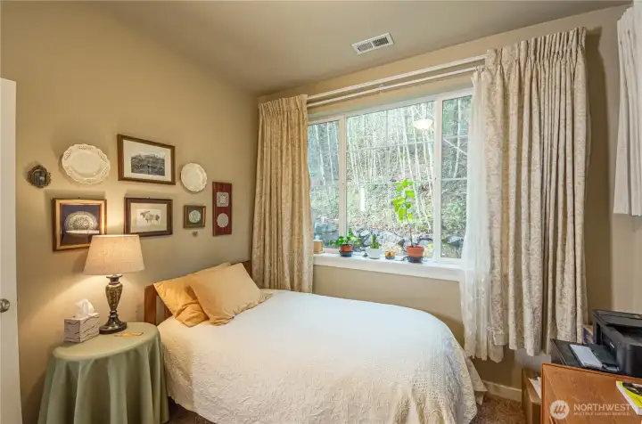 Serene views of wooded backyard make this a welcoming space. And if you make this your guest bedroom, the 3/4 bathroom located right next to it, makes this even more convenient and pleasant for your guests.