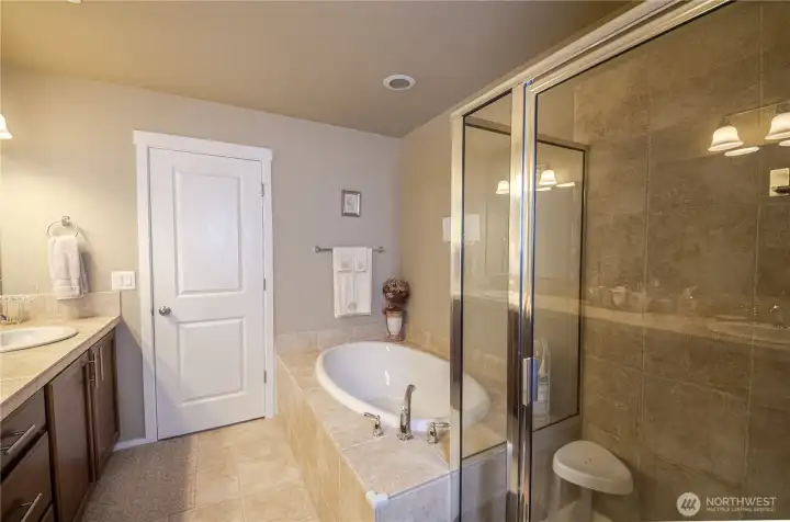 A luxurious sunken soaking tub with a tiled surround. Imagine yourself surrounded by scented candles, potpourri and maybe a glass of wine or two.