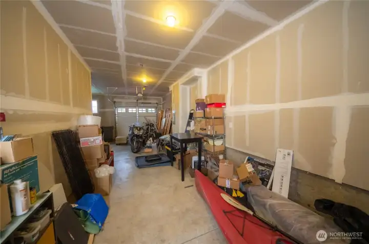 The tandem garage can comfortably fit a couple of cars with additional room on the far left for a fridge, freezer, gardening supplies and more.