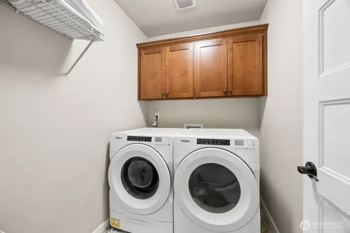 Upstairs laundry room w/ custom cabinetry.