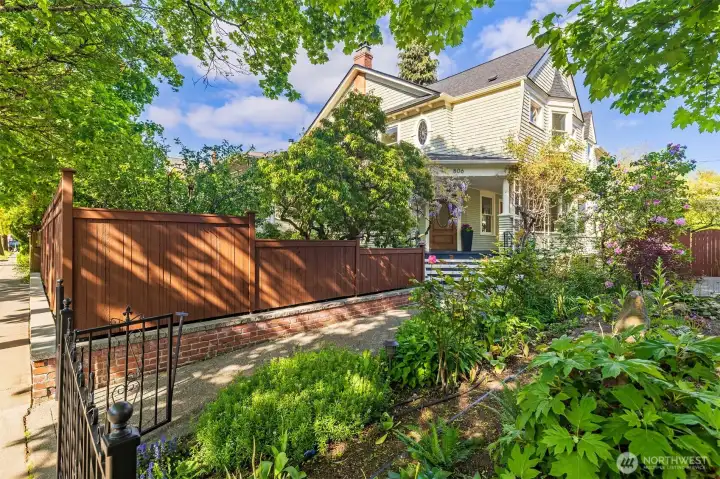 An elegant, quiet home, tucked into the property and flanked by blooming gardens