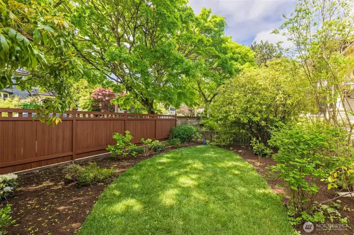 The front yard offers a spot for putt putt golf amidst a green garden