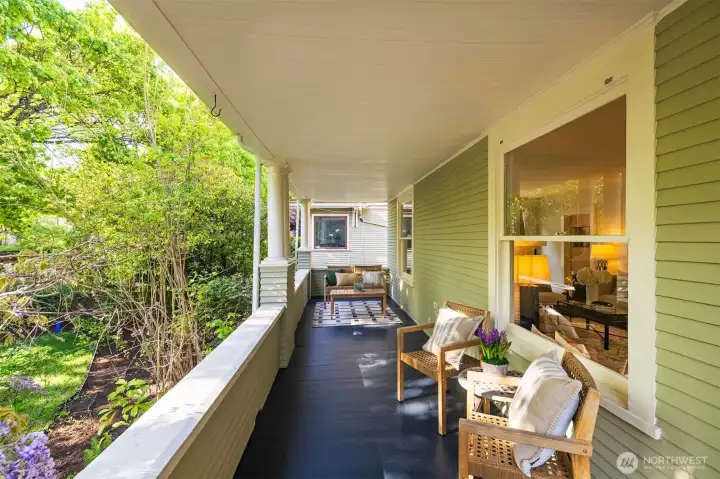 This front porch is wide enough to accommodate  several seating areas
