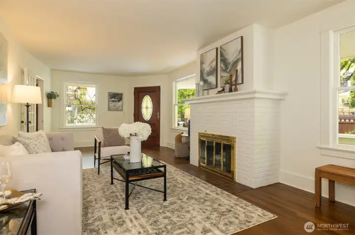 The large living room with wood burning fireplace and handsome hearth