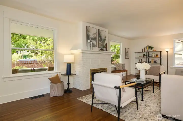 Living room windows face the covered porch and gardens