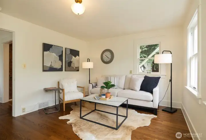 The main floor, 5th bedroom, staged as a den, offers a full bath next door