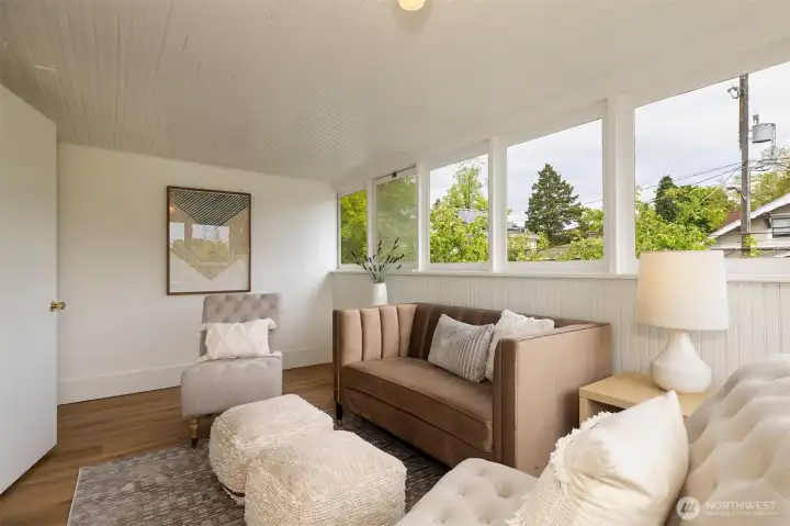 This sun porch is staged as a den