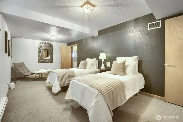 Spacious lower-level bedroom with a private bathroom and walk-in closet.