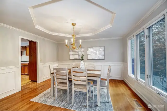 Dining Room to the right as you enter the front door. Recessed ceiling and wainscoting. Beautiful large windows overlooking the front driveway & yard.