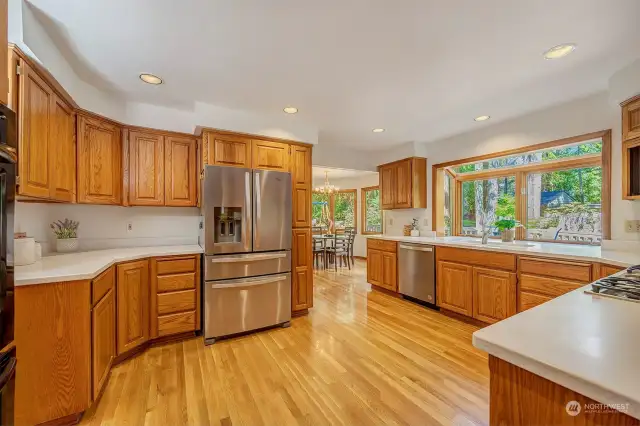 Kitchen with hardwood floors. Bay window brings in natural light and overlooks the yard.