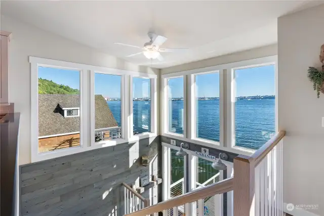 Impressive floor to ceiling windows flood the home with tons of natural light and a nautical backdrop!