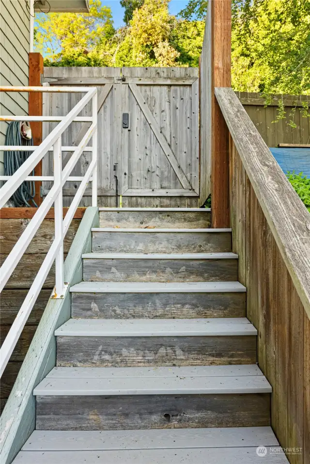 From exterior door, access 2 staircases that lead up to road and down to water.