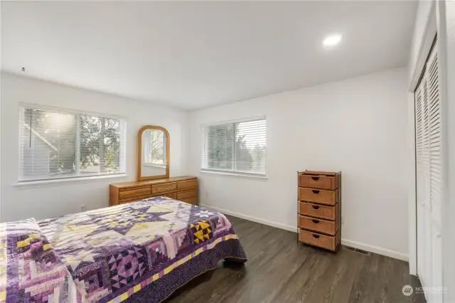 View of large bedroom #2 with double windows new lvp flooring and paint