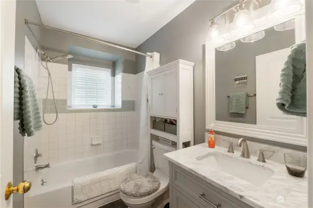 Upstairs newly remodeled bathroom with quartz counters new lighting and paint