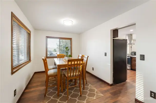 Check out this large dining room off entry and kitchen with seating for 8-12 people with more new interior paint and lighting to enjoy.  There is wood wrapped windows and wood blinds to match wood flooring/trim