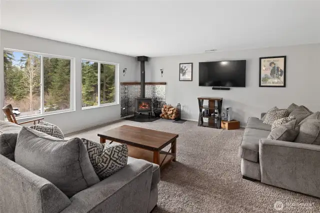 Open concept living room with a wood stove to keep you warm and cozy all winter long.