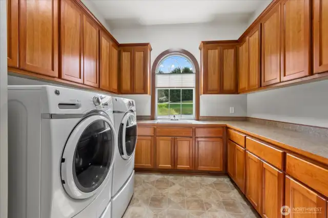 Laundry room with abundant storage.