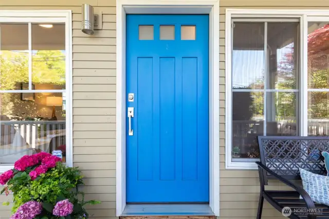 An extended covered porch welcomes you - plenty of room for seating on each side of the door.