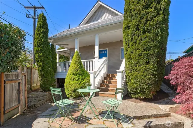Looking at the back of the house - the blue door is to the kitchen. Gate at left is to the detached garage.