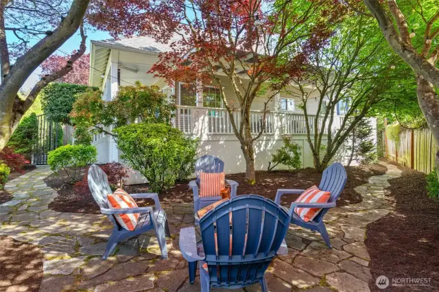 Flagstone sitting area nestled amongst the maple trees.