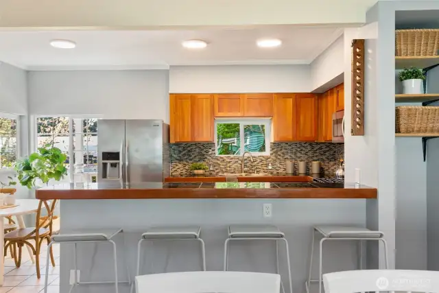 Extensive tiled backsplash, plenty of cabinets and lots of counter space.