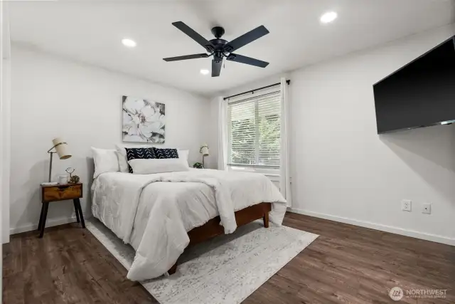 The primary bedroom offers the privacy of an attached 3/4 en suite bath.