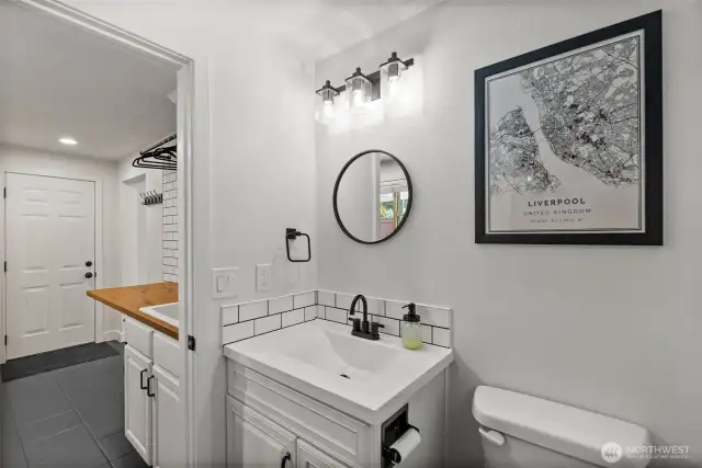 Beyond the laundry room, discover a freshly updated full bath.