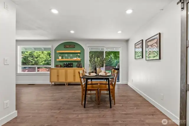 The home features an expansive, light-filled dining room that seamlessly connects to the backyard, perfect for entertaining.