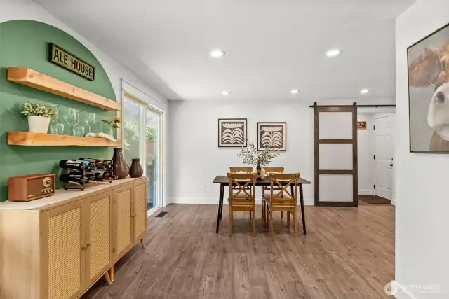 A feature wall in the large, light-filled dining room provides the perfect backdrop for your home bar or collectibles.