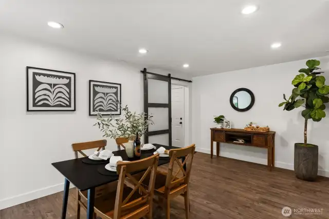 Modern barn door leads to laundry room.