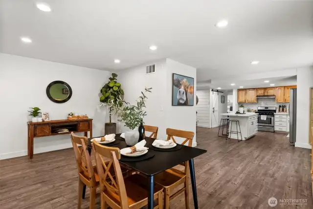 This photo perfectly captures the open-concept design, seamlessly connecting the dining room, kitchen, and living room.