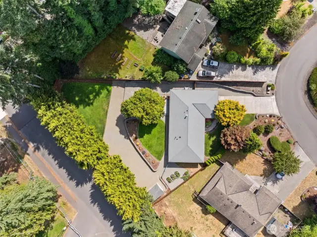 This overhead view showcases the mature landscaping providing excellent privacy, and highlights the expansive backyard.