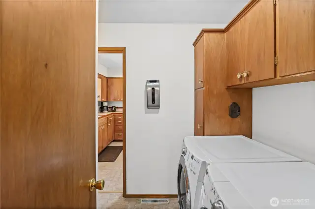Laundry room situated between the kitchen and the Primary bedroom, the 1/2 bath is there as well. Great placement