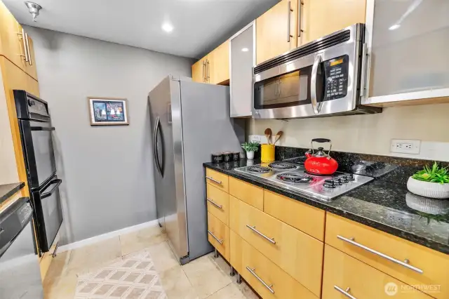The kitchen also has a brand new  refrigerator, recently replaced microwave,  stove top range, and cool frosted glass  cabinets.