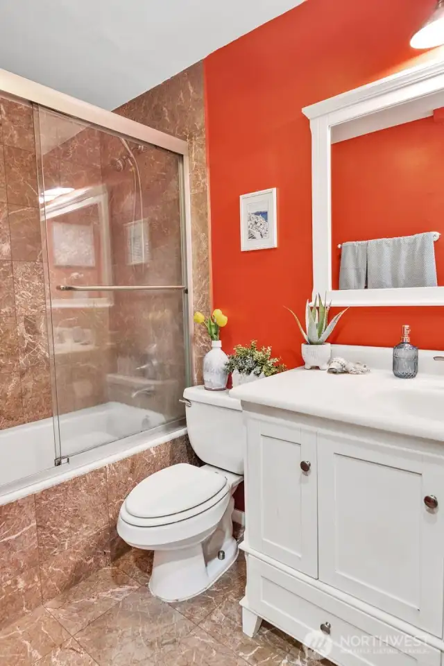 This photo shows the large/deep jetted tub  and luxurious marble and glass surround!