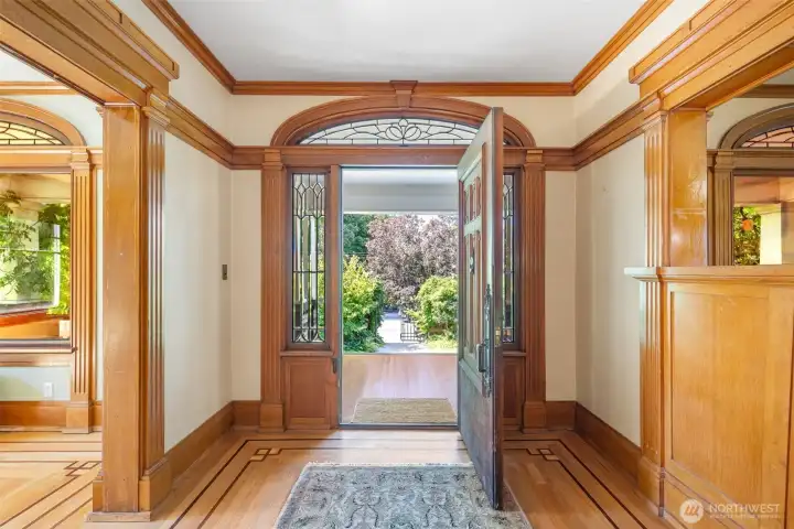 Preserved and restored features; light stained woodwork, stained glass and original windows, intricate inlaid floors, and original/vintage light fixtures.