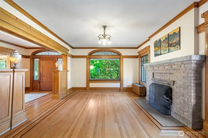 Formal living room overlooks the front porch and has a grand fireplace as an anchor.
