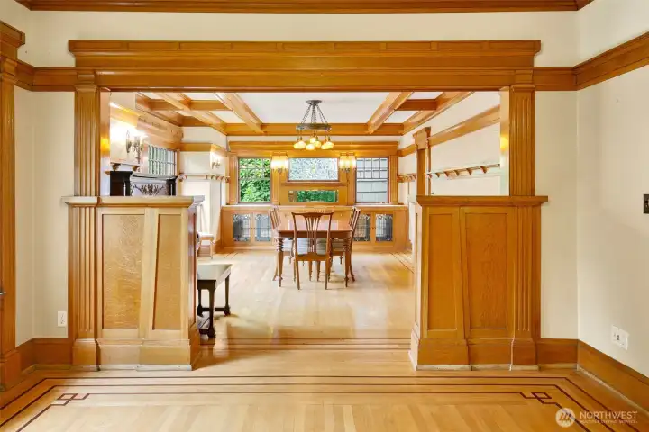 Light stained craftsman millwork (with a nod to an Art Deco style), the formal living room leads directly to the formal dining.