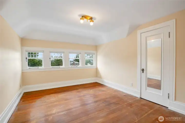 Top floor west facing bedroom, flanked by large closets on both sides. There is an equally sized bedroom on the east side of the house.